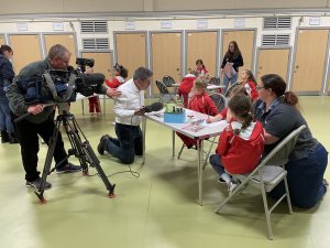 Impact report image: BBC reporter and camera crew interviewing Rainbows at a Stalham unit about Queen Elizabeth II's Platinum Jubilee